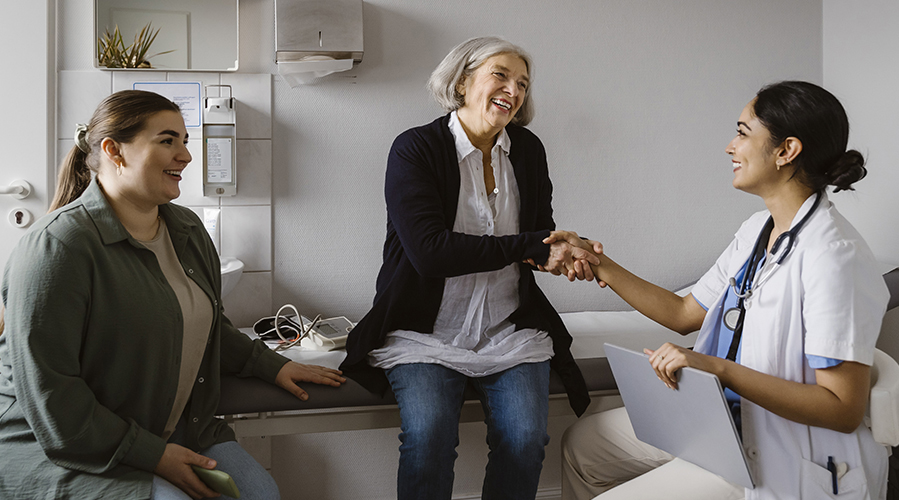 Close up of a senior woman and her daughter having a doctors appointment