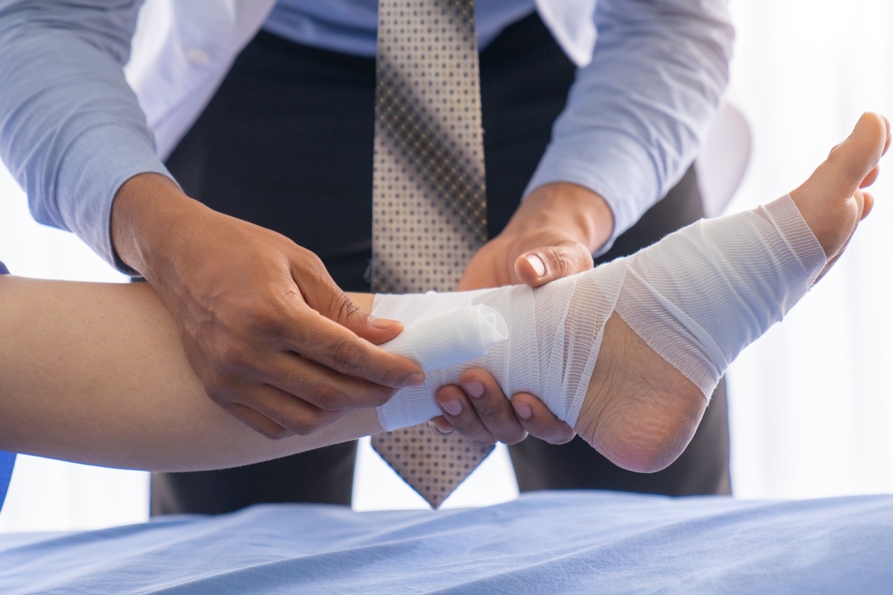Podiatrist bandaging foot