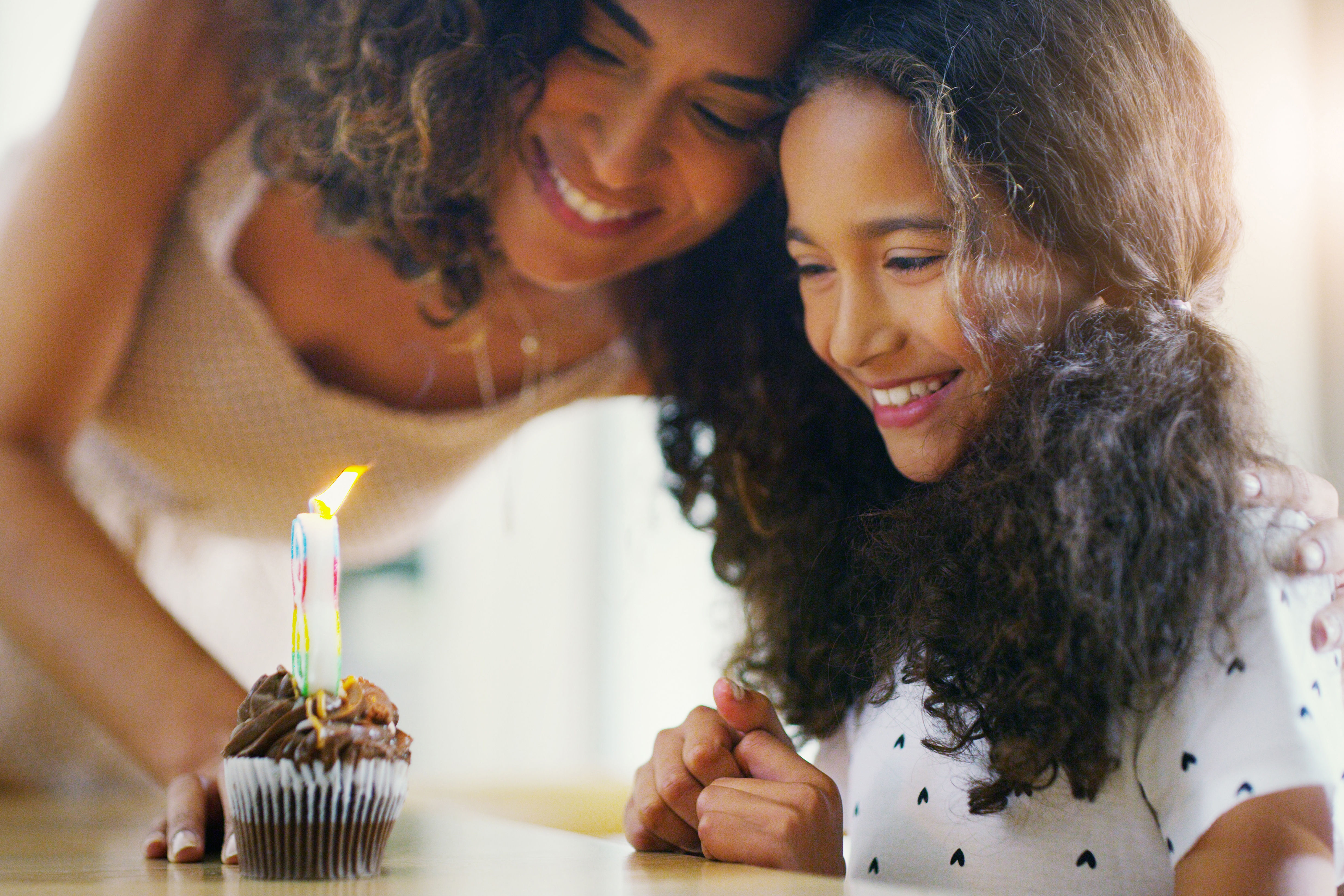 Shot of a young mother and daughter celebrating a birthday at home
