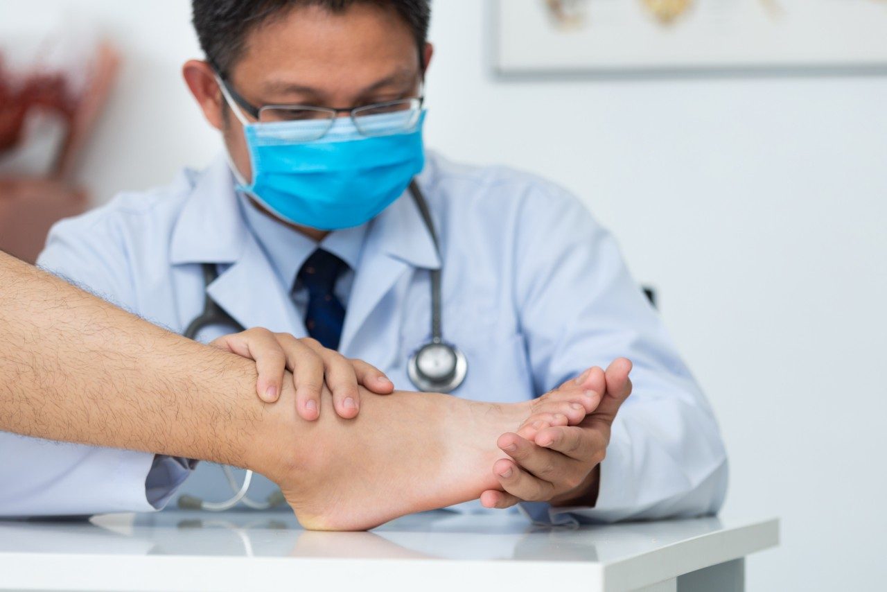 Podiatrist examining foot