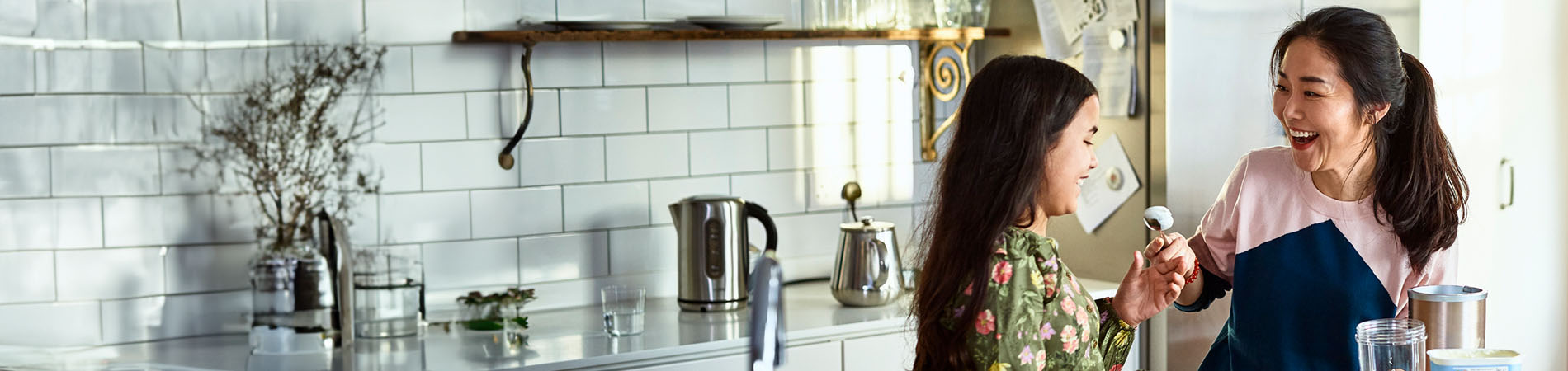 Asian woman with young girl in a kitchen