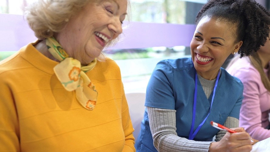 female patient and provider laughing in waiting room