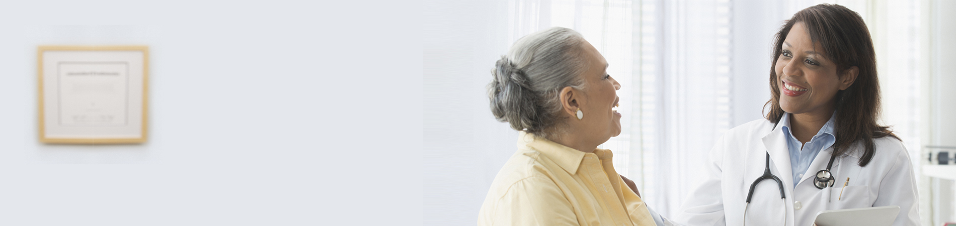 Older woman talking to doctor in office