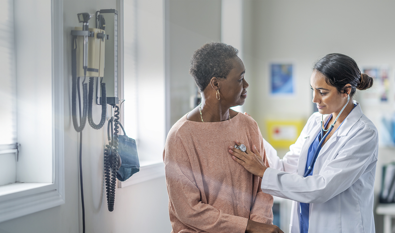 doctor examining patient in office