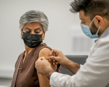 woman getting bandaid on arm