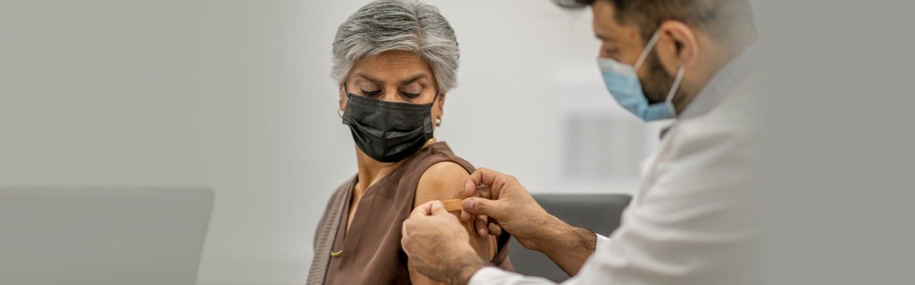 woman getting bandaid on arm