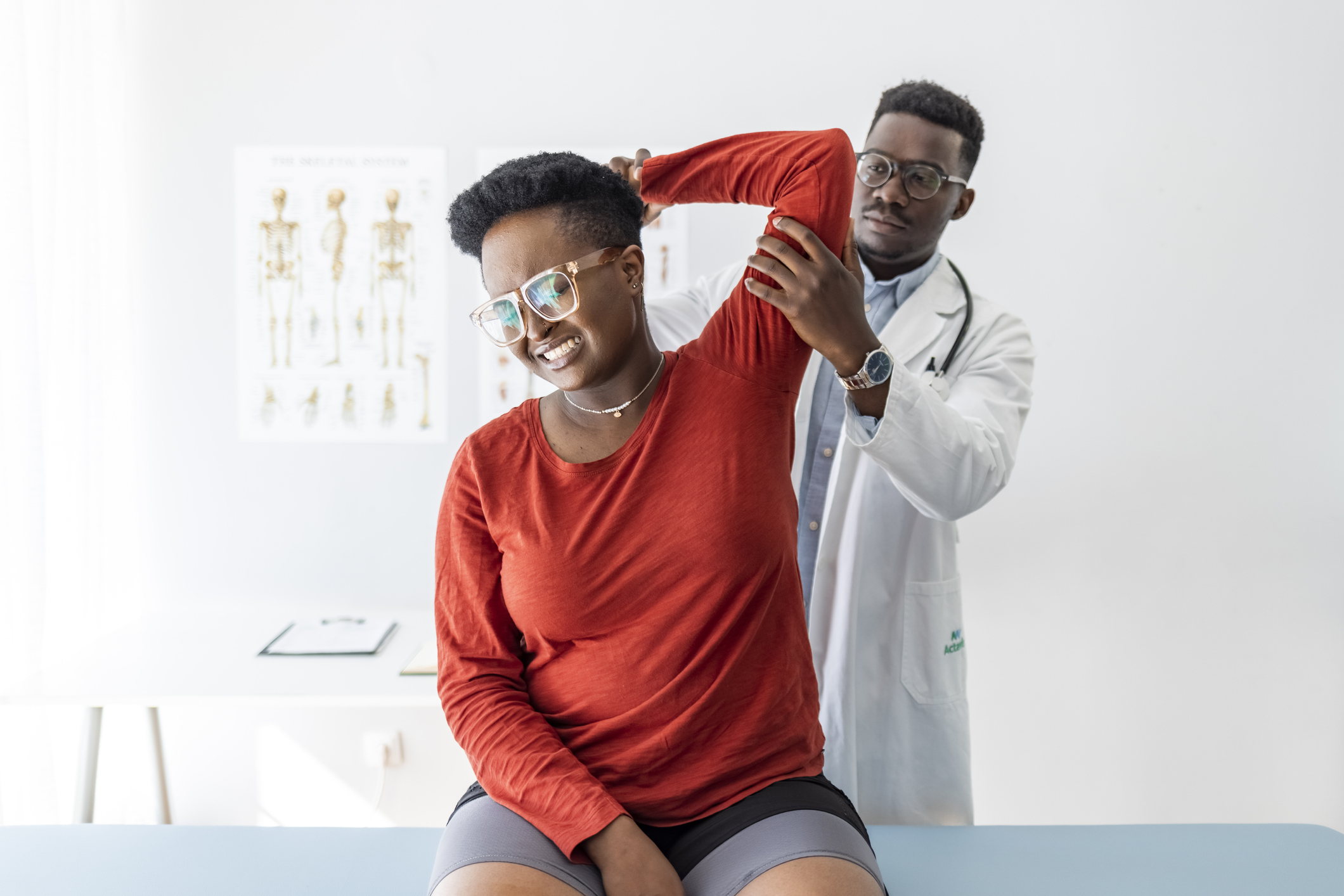 Shot of a young male physiotherapist assisting a female patient in recovery