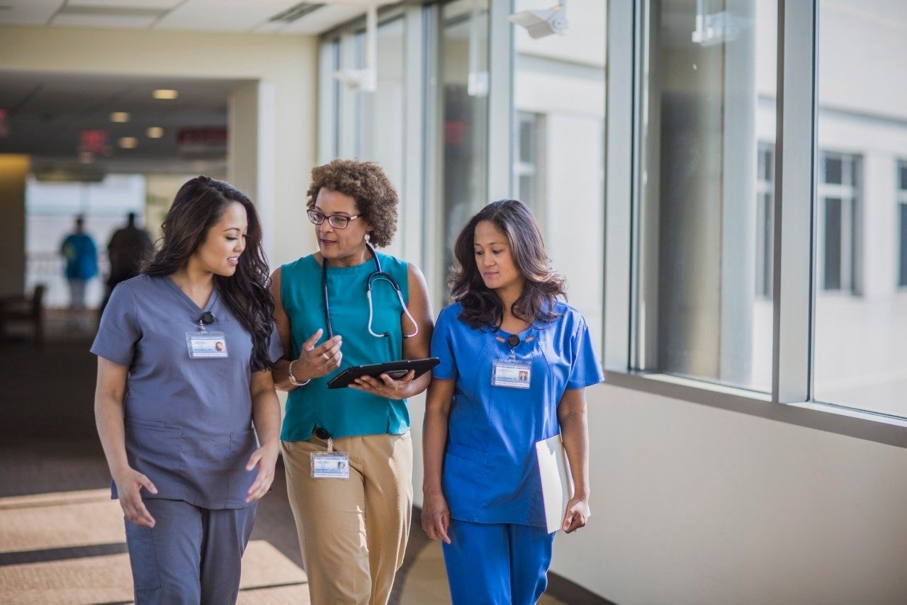 Nurses and doctor using digital tablet