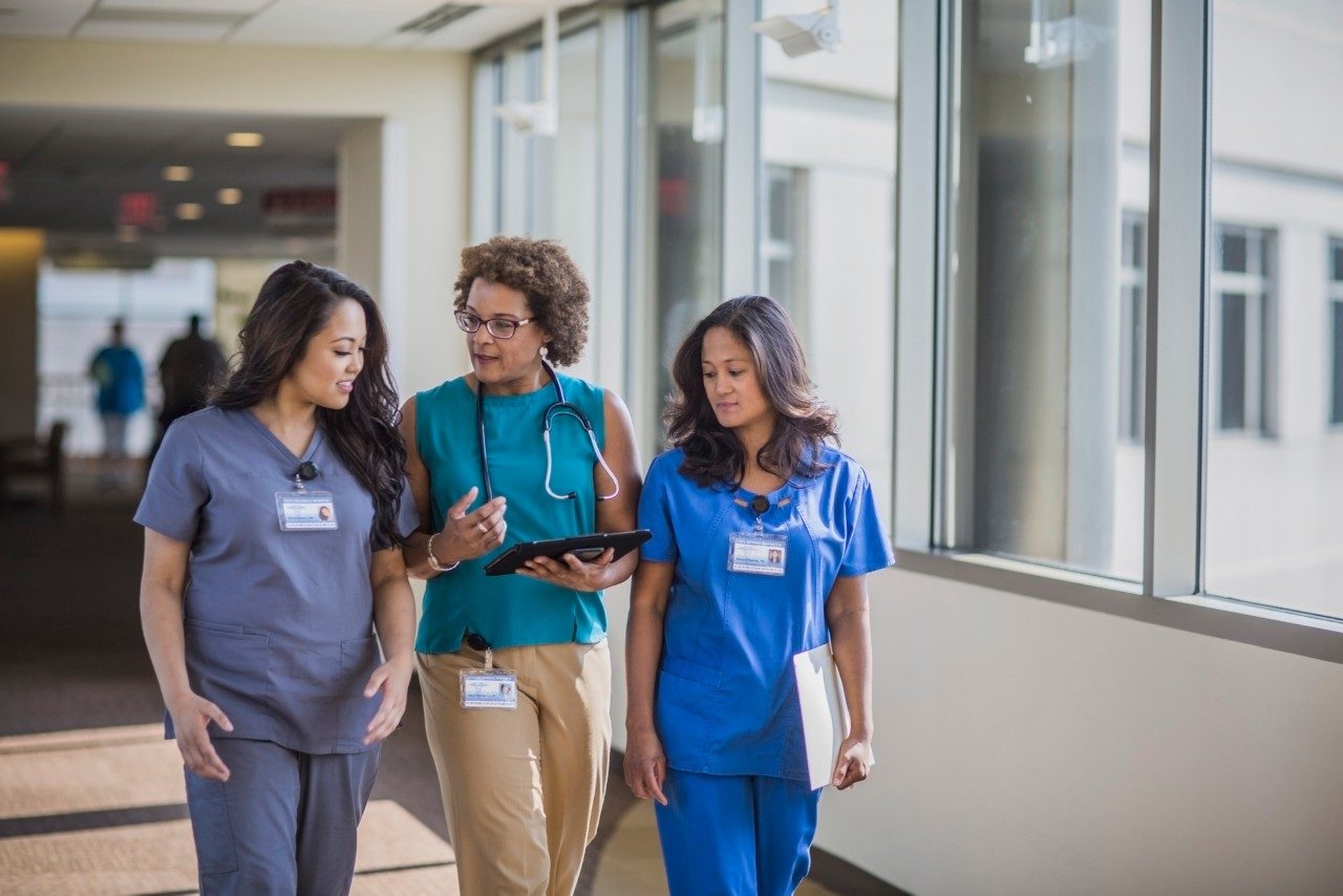 Nurses and doctor using digital tablet