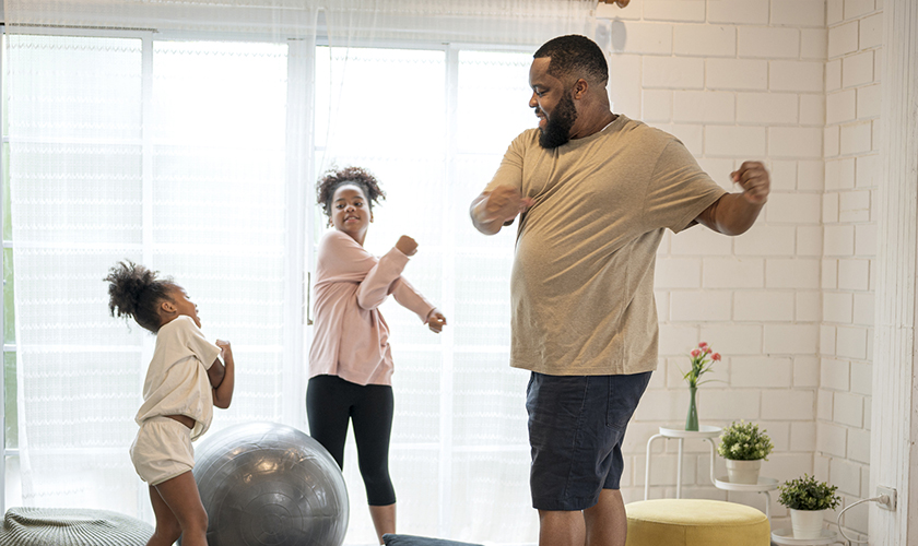 African father and his two daughter morning exercise at home.