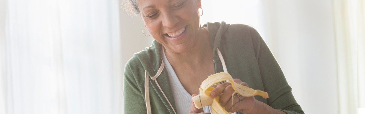 woman slicing a banana