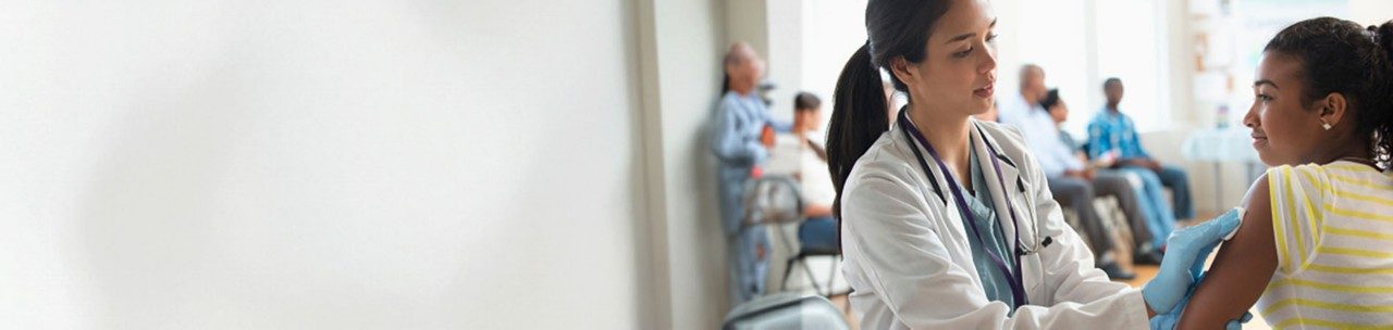 Doctor disinfecting arm of patient in volunteer clinic