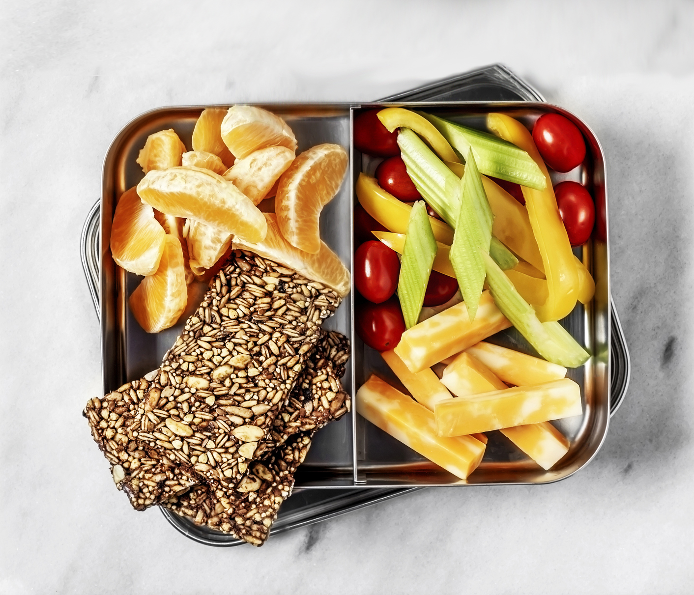 A couple of lunch boxes on white, stone background