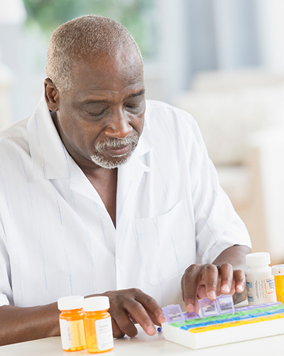 Senior man arranging meds