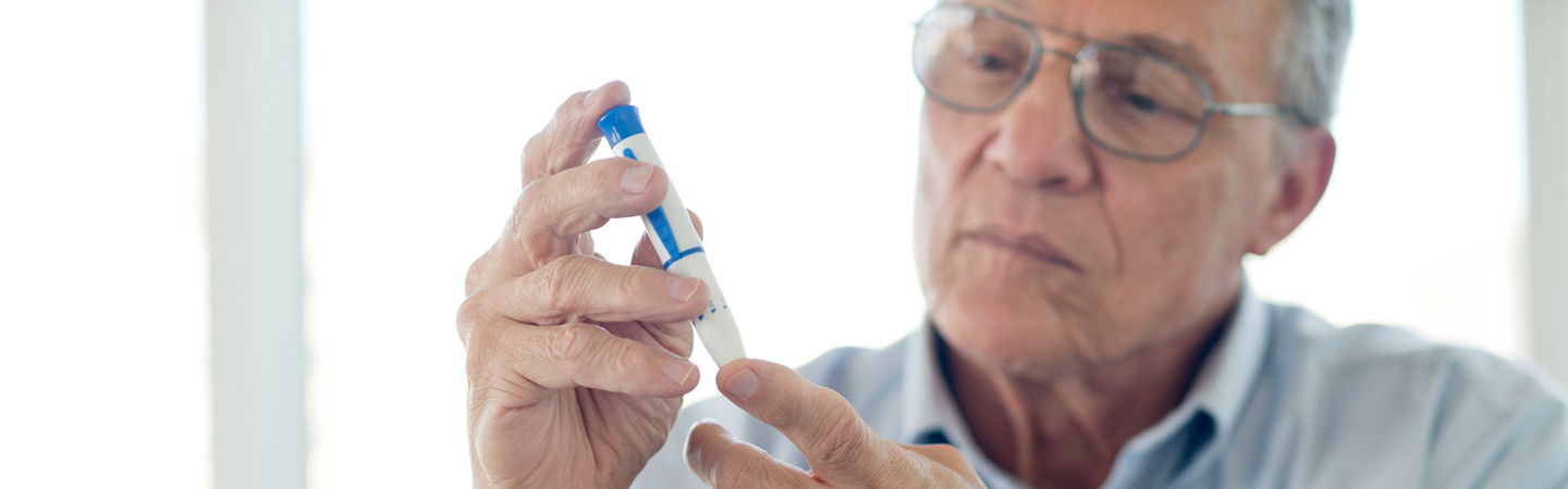 man checking blood sugar levels
