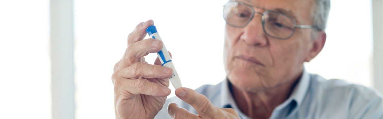 man checking blood sugar levels