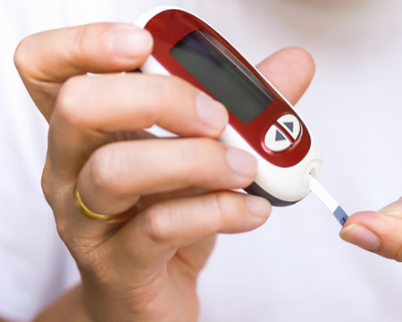 hands testing blood sugar