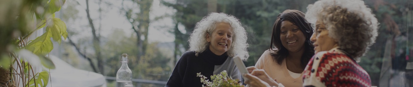 smiling women looking at a mobile phone